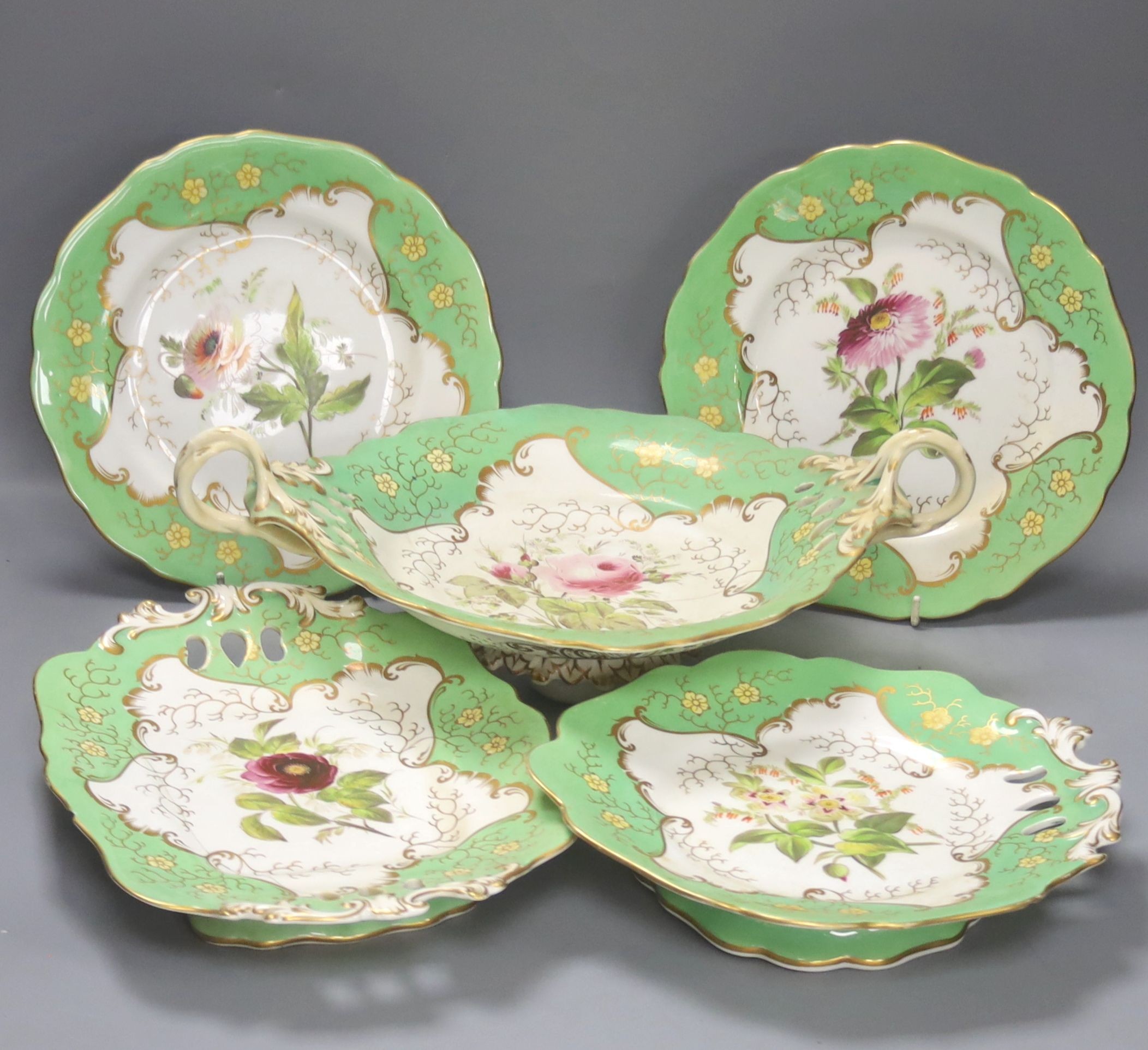 A mid 19th century Staffordshire porcelain 24 piece green bordered part dessert service, painted with floral prays